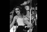 A woman and her nephew enjoy a Merry-go-round.