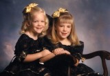 Two sisters in a studio portrait pose