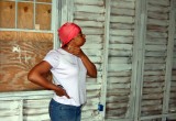 A Hurricane Katrina victim surveys improvements being done to her home