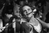 A baton twirler peforms for parade goers